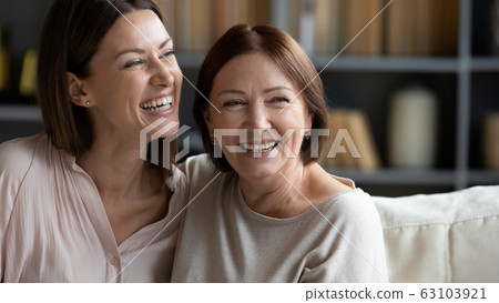 Smiling two female generation family dreaming of future together. 63103921
