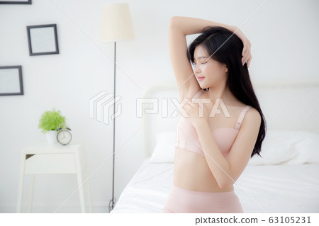 Beautiful young asian woman in underwear applying cream and lotion on armpit 63105231