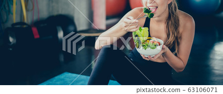 Beautiful young lady with salad in the Gym. Sport 63106071