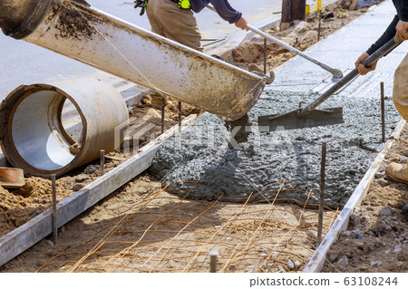 Truck loads of concrete poured into the concrete 63108244