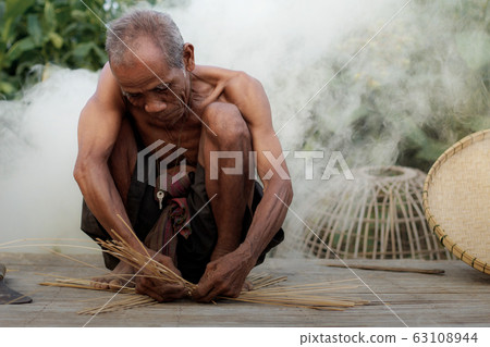 Old man is weaving baskets. Old man is weaving baskets. 63108944