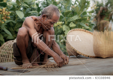 old man is weaving bamboo. old man is weaving bamboo. 63108946