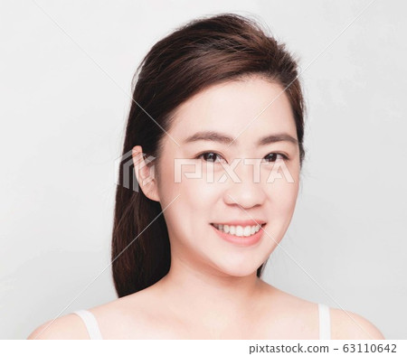young beautiful asian woman with clean and bright skin, Cosmetic Beauty Concept,smiling face young beautiful asian woman with clean and bright skin, Cosmetic Beauty Concept,smiling face 63110642