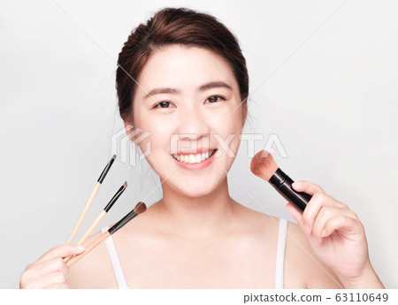 young beautiful asian woman with clean and bright skin, Cosmetic Beauty Concept,smiling face young beautiful asian woman with clean and bright skin, Cosmetic Beauty Concept,smiling face 63110649