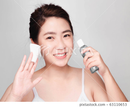 young beautiful asian woman with clean and bright skin, Cosmetic Beauty Concept,smiling face 63110653