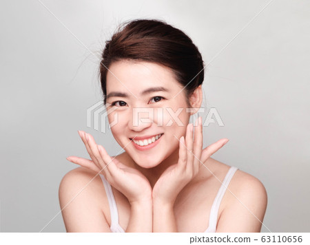 young beautiful asian woman with clean and bright skin, Cosmetic Beauty Concept,smiling face 63110656