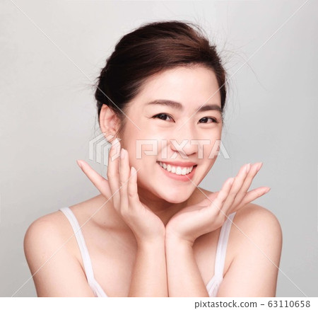 young beautiful asian woman with clean and bright skin, Cosmetic Beauty Concept,smiling face 63110658