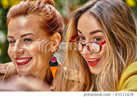A middle-aged red-haired woman in a brown coat A middle-aged red-haired woman in a brown coat 63111826