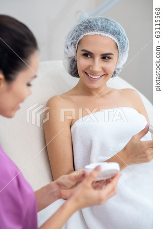 Woman feeling happy spending time in beauty salon 63115568