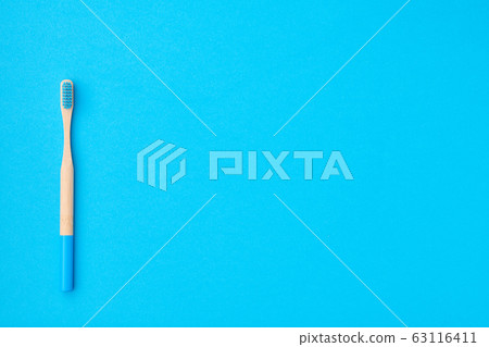 Toothbrush on blue background top view Toothbrush on blue background top view 63116411