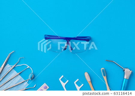 Dentist tools over blue background top view Dentist tools over blue background top view 63116414