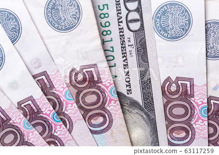 Ruble Russian currency and dollar close-up. Exchange rate. The dollar to ruble exchange rate. Ruble Russian currency and dollar close-up. Exchange rate. The dollar to ruble exchange rate. 63117259