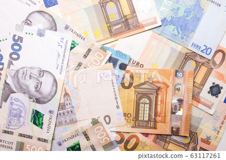 Dollar euro hryvnia closeup. The texture of the currencies of different countries. Dollar euro hryvnia closeup. The texture of the currencies of different countries. 63117261