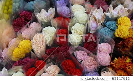 A variety of colorful flowers wrapped in transparent wrappers. View from above. A variety of colorful flowers wrapped in transparent wrappers. View from above. 63117615