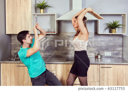 Young couple are fighting in the kitchen. Young couple are fighting in the kitchen. 63117755