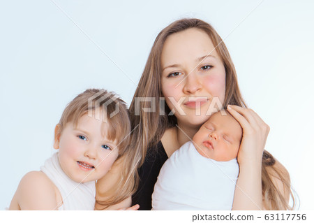 concept of healthy lifestyle, the protection of children, shopping - baby in the arms of the mother. Woman holding a child. Tree girls. Isolated on white background. Copy space. 8 march, mother's day concept of healthy lifestyle, the protection of children, shopping - baby in the arms of the mother. Woman holding a child. Tree girls. Isolated on white background. Copy space. 8 march, mother's day 63117756