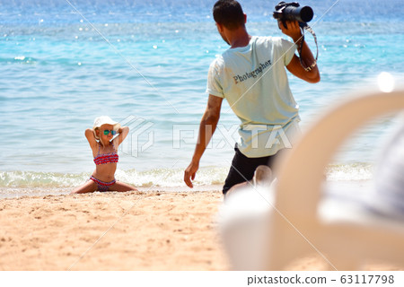 Little girl in a swimsuit poses for the Little girl in a swimsuit poses for the 63117798