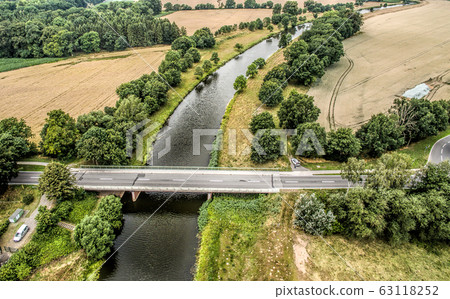 Aerial photo of a small river with a bridge 63118252