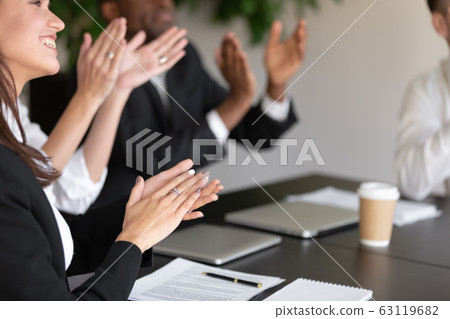 Close up overjoyed female male coworkers applauding. Close up overjoyed female male coworkers applauding. 63119682