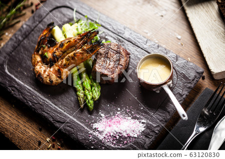 Tasting menu. Beef steak and grilled tiger prawns. 63120830