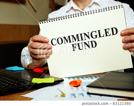 Commingled Fund papers in the man hands. Commingled Fund papers in the man hands. 63121360