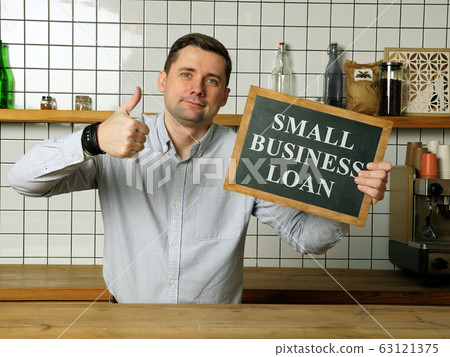 Small business loan in the businessman hands. Small business loan in the businessman hands. 63121375