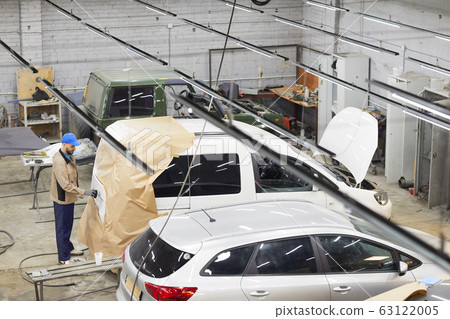 Man Working Alone In Auto Service Center 63122005
