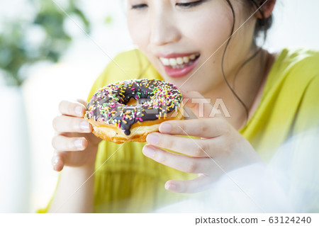 Young woman donut 63124240