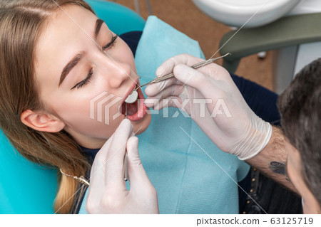 patient in dentist chair with open mouth 63125719