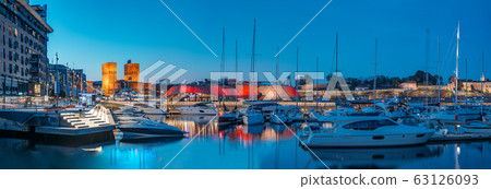 Oslo, Norway. Night View Embankment, Oslo City Hall And Moored Yachts Near Aker Brygge District. Summer Evening. Famous And Popular Place Oslo, Norway. Night View Embankment, Oslo City Hall And Moored Yachts Near Aker Brygge District. Summer Evening. Famous And Popular Place 63126093