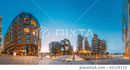 Oslo, Norway. Night View Of Residential Multi-storey Houses In Aker Brygge District. Summer Evening. Residential Area. Famous And Popular Place. Panorama. Oslo, Norway. Night View Of Residential Multi-storey Houses In Aker Brygge District. Summer Evening. Residential Area. Famous And Popular Place. Panorama. 63126110