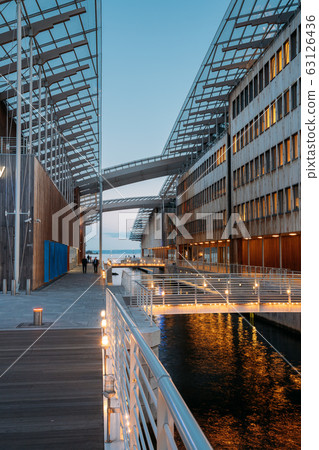Oslo, Norway. Night View Embankment And Residential Multi-storey Houses In Aker Brygge District. Summer Evening. Residential Area Reflected In Sea Waters. Famous And Popular Place Oslo, Norway. Night View Embankment And Residential Multi-storey Houses In Aker Brygge District. Summer Evening. Residential Area Reflected In Sea Waters. Famous And Popular Place 63126436