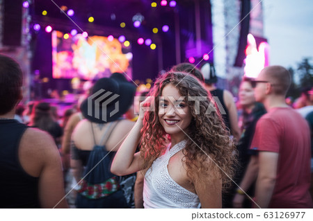 Beautiful young woman at summer festival, looking at camera. Beautiful young woman at summer festival, looking at camera. 63126977