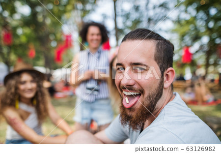 Group of young friends at summer festival, drug dealing concept. Group of young friends at summer festival, drug dealing concept. 63126982