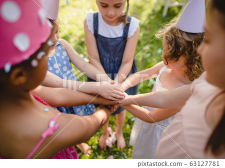 Children playing outdoors on birthday party in garden in summer. Children playing outdoors on birthday party in garden in summer. 63127781