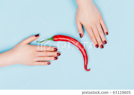 Female hands with spicy red pepper Female hands with spicy red pepper 63128605