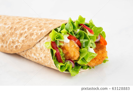 Wrap with fried chicken and vegetables isolated on a white background Wrap with fried chicken and vegetables isolated on a white background 63128883