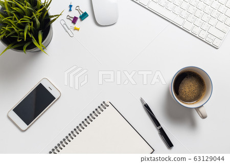 Top view, empty notebook and office supplies isolated on white background Top view, empty notebook and office supplies isolated on white background 63129044
