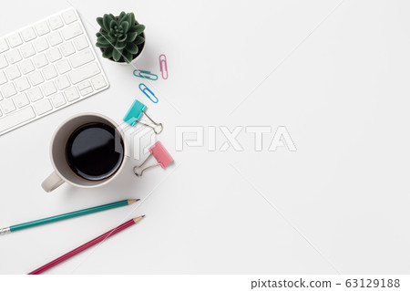 Top view, Workspace desk With coffee and office supplies on white background Top view, Workspace desk With coffee and office supplies on white background 63129188