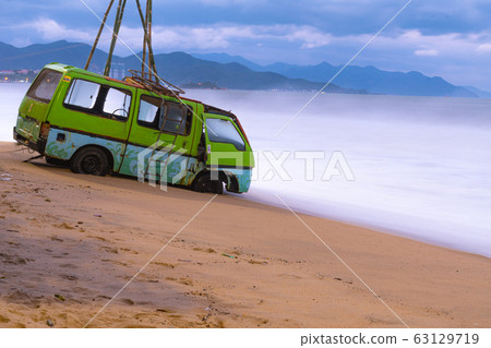 Old car parked on beach. Old car parked on beach. 63129719