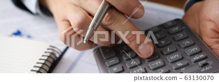 Man analyzes cost renting, counting on calculator 63130070
