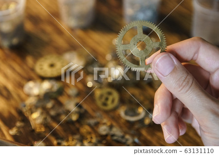 Female master works in her workshop. 63131110