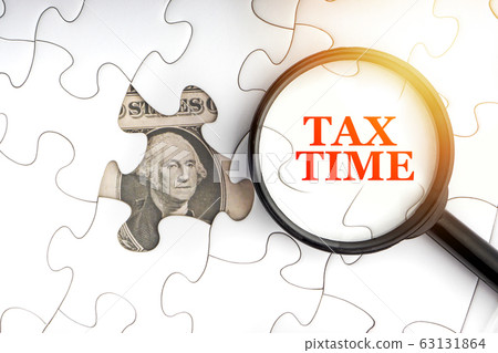 TAX TIME text with Dollar banknotes on white TAX TIME text with Dollar banknotes on white 63131864