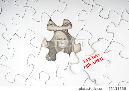 TAX DAY 15 APRIL text with Dollar banknotes on 63131866