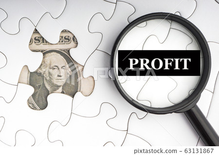 PROFIT text with Dollar banknotes on white jigsaw 63131867