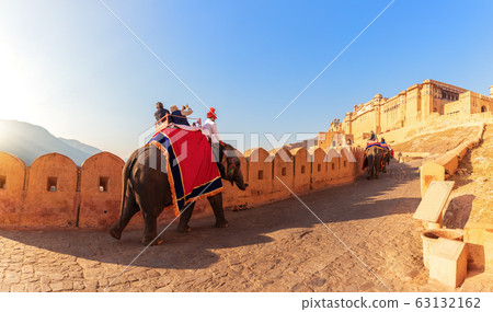 Amber Fort panorama: tourists on the elephants, 63132162