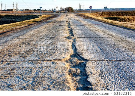 Dangerous asphalt road with holes destroyed. 63132315