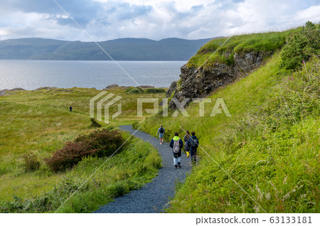 Tourists walking at the eastern cape of Mull island, Scotland Tourists walking at the eastern cape of Mull island, Scotland 63133181