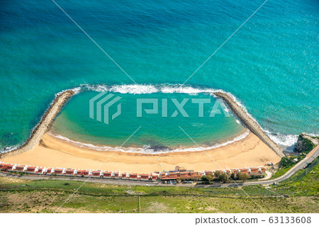 beach on ocean coast with barriers to protect against waves and water predators beach on ocean coast with barriers to protect against waves and water predators 63133608