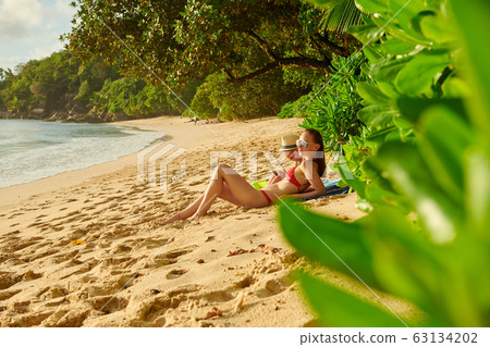 Toddler boy on beach with mother 63134202